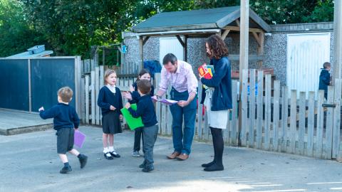 Teachers talking to pupils in the playground