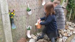 Watering the plants in wellies