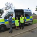 Junior Road Safety Officers looking in Police van with Mr Marshall